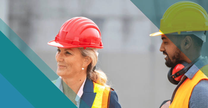 Female construction executive speaking with male construction coworkers