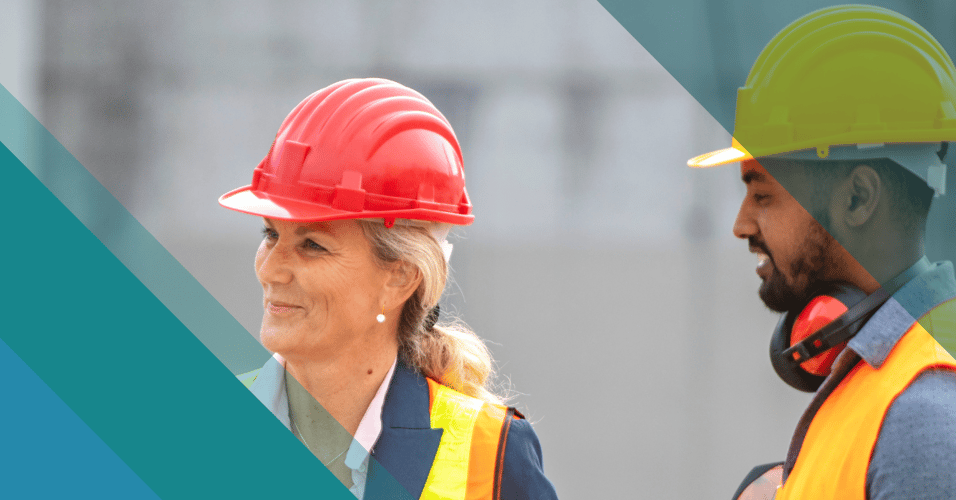 Female construction executive speaking with male construction coworkers