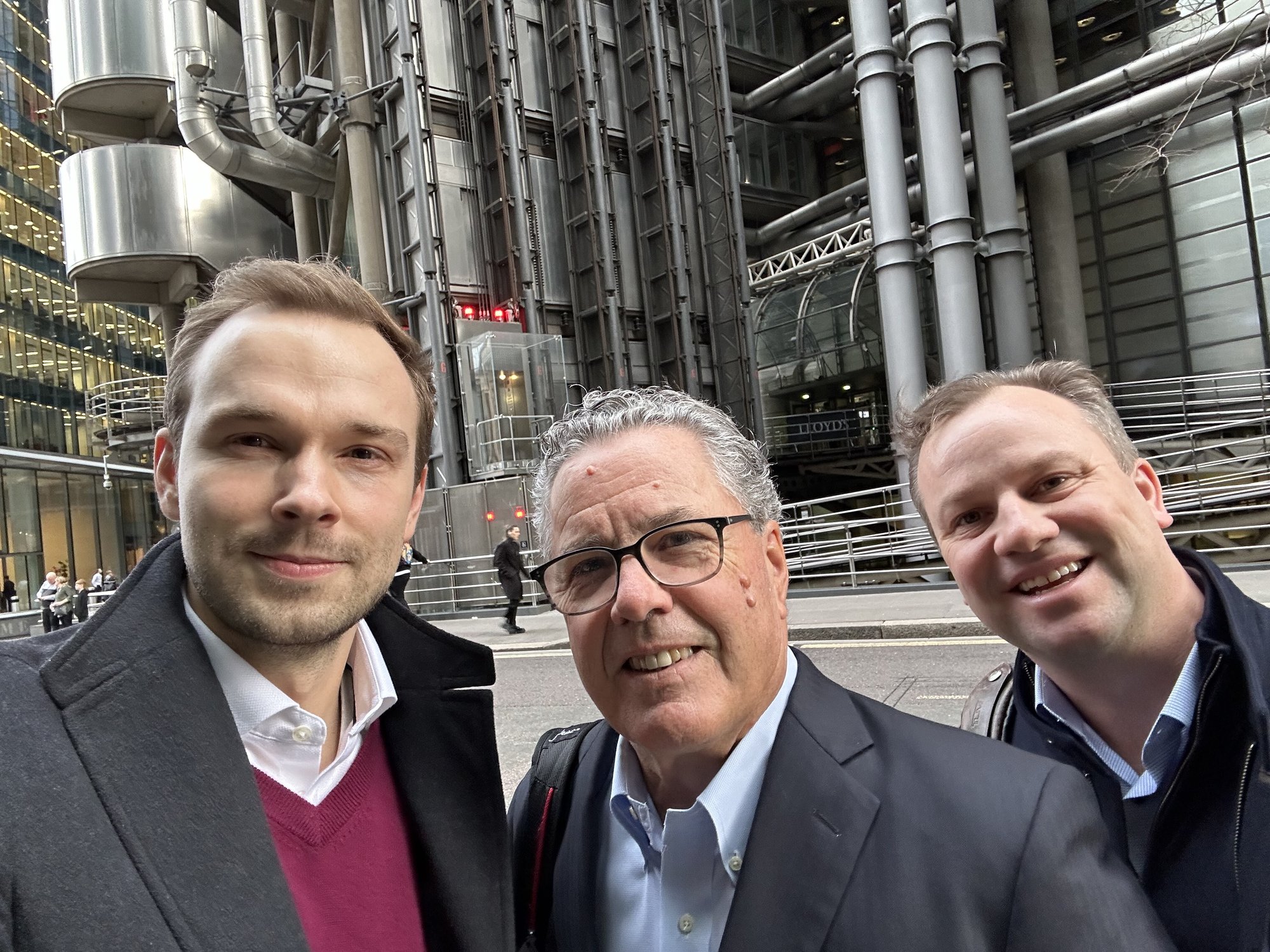 Victor Nieznalski, John Dempsey, and Chad Hollingsworth pose outside of Lloyd's of London in February 2024.